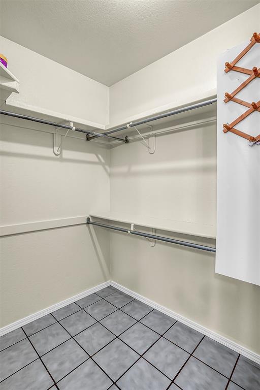 walk in closet featuring tile patterned flooring