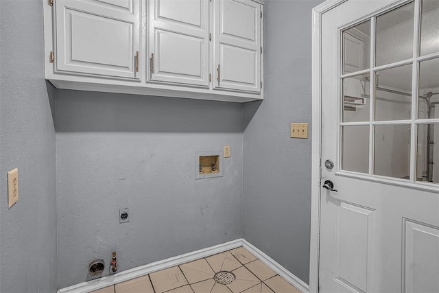 clothes washing area featuring washer hookup, hookup for a gas dryer, cabinet space, light tile patterned flooring, and electric dryer hookup