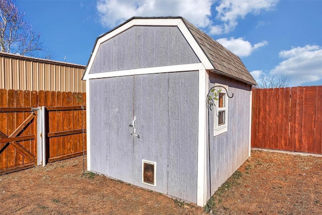 view of shed featuring fence