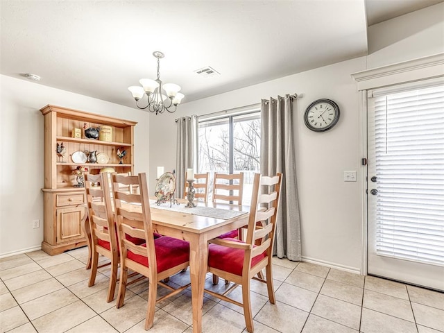 dining area with an inviting chandelier, baseboards, light tile patterned floors, and visible vents