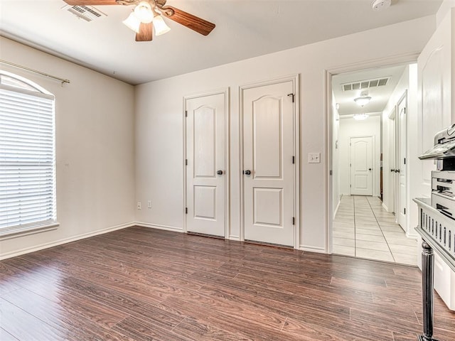 interior space featuring visible vents, ceiling fan, and wood finished floors