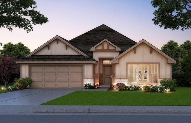 view of front facade featuring a garage, a shingled roof, a yard, stone siding, and driveway