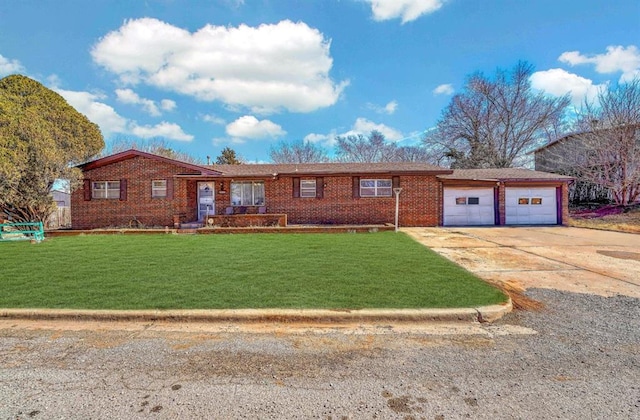 ranch-style home with an attached garage, driveway, brick siding, and a front yard