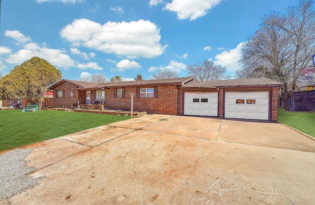 ranch-style house featuring a front yard, brick siding, driveway, and an attached garage