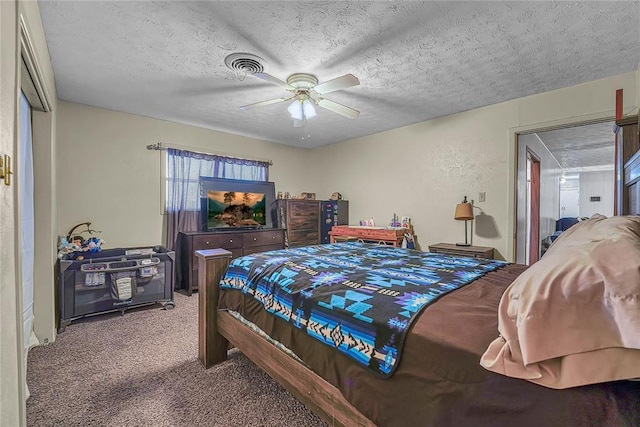 carpeted bedroom featuring a ceiling fan, visible vents, a textured ceiling, and a textured wall