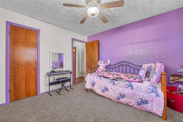 bedroom with carpet flooring, ceiling fan, and a textured ceiling