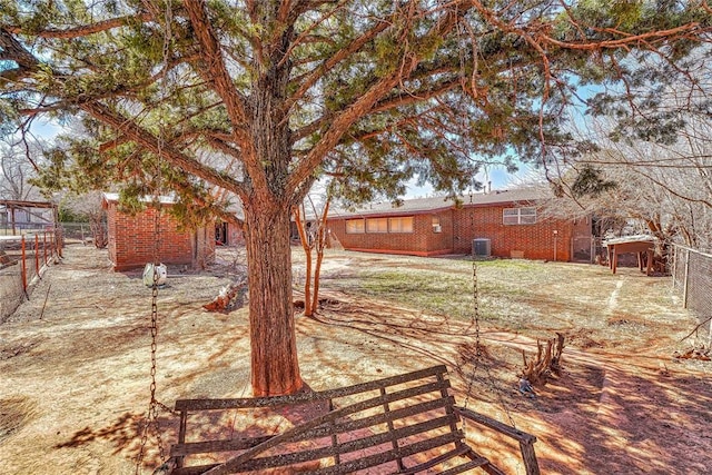 view of yard with central AC unit and fence