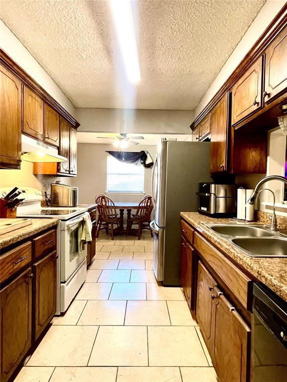 kitchen featuring ceiling fan, under cabinet range hood, white electric range, a sink, and dishwasher