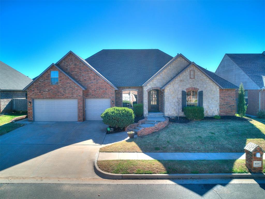 view of front of property featuring concrete driveway, brick siding, and an attached garage