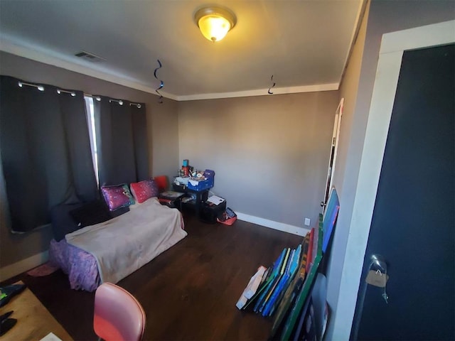 bedroom featuring wood finished floors, visible vents, and baseboards