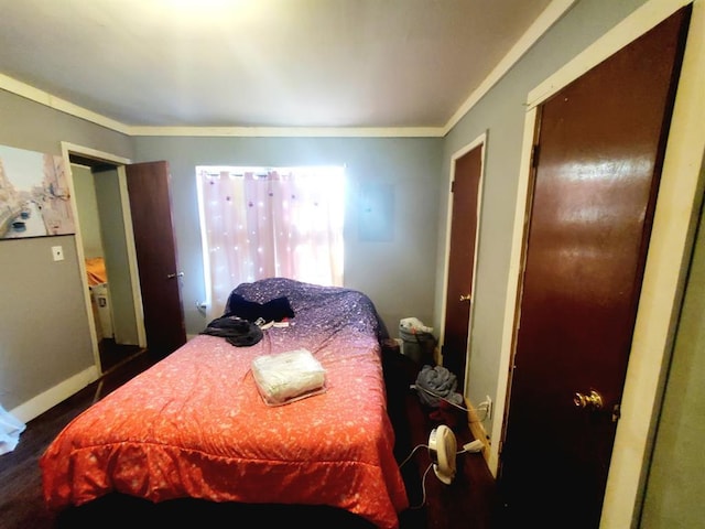 bedroom featuring baseboards and crown molding