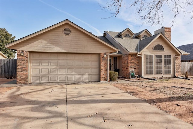 view of front of property with a garage, concrete driveway, and brick siding