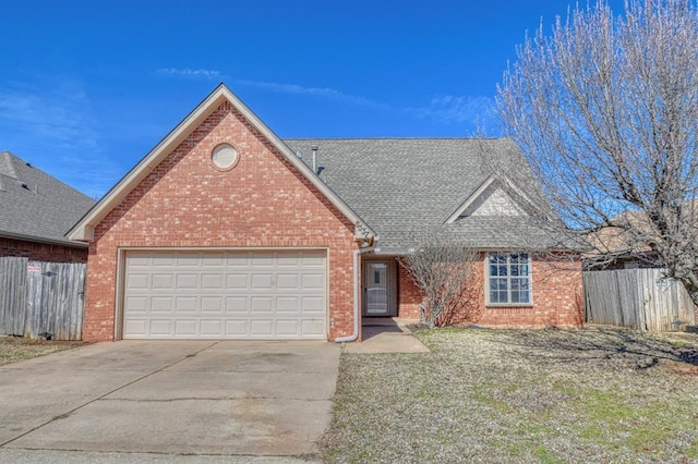 view of front of home featuring an attached garage, brick siding, fence, driveway, and roof with shingles