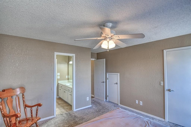 bedroom featuring light colored carpet, a textured ceiling, and a textured wall