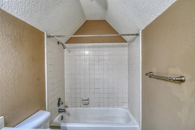 full bathroom with lofted ceiling, a textured wall, shower / bathing tub combination, toilet, and a textured ceiling