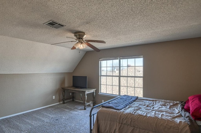 unfurnished bedroom with carpet floors, visible vents, a textured ceiling, and lofted ceiling