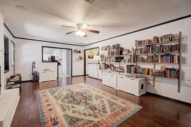 interior space with ornamental molding, a textured ceiling, and wood finished floors