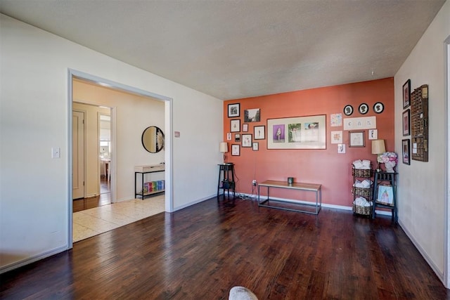 playroom with baseboards and wood finished floors