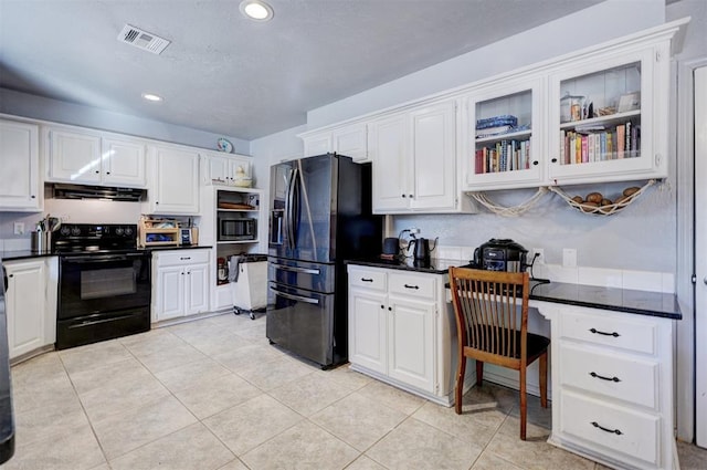 kitchen with visible vents, black / electric stove, built in microwave, under cabinet range hood, and stainless steel refrigerator with ice dispenser