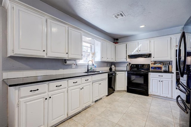 kitchen featuring extractor fan, a sink, visible vents, white cabinets, and black appliances