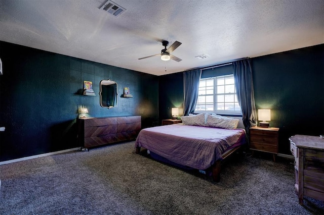 bedroom with carpet floors, ceiling fan, visible vents, and a textured ceiling