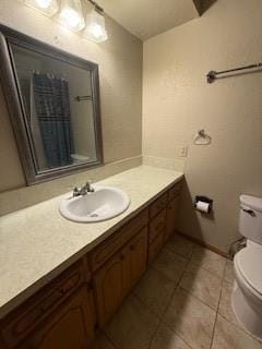 bathroom with vanity, toilet, and tile patterned floors