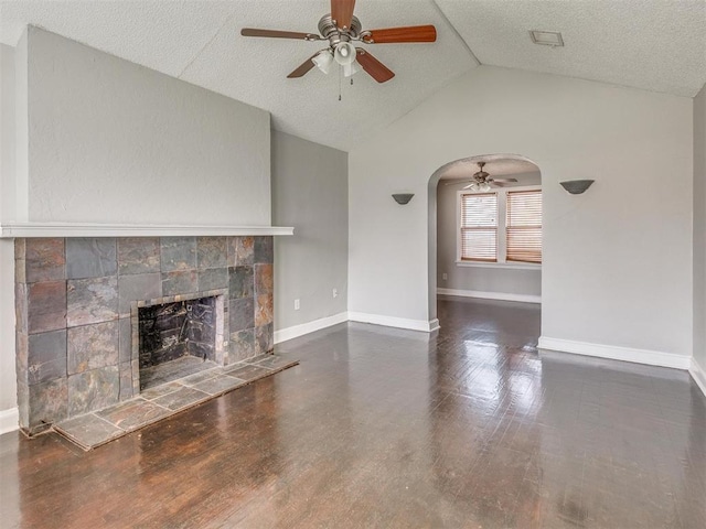 1817 NW 32nd St, Oklahoma City, OK 73118 - unfurnished living room featuring lofted ceiling, baseboards, a fireplace, and arched walkways