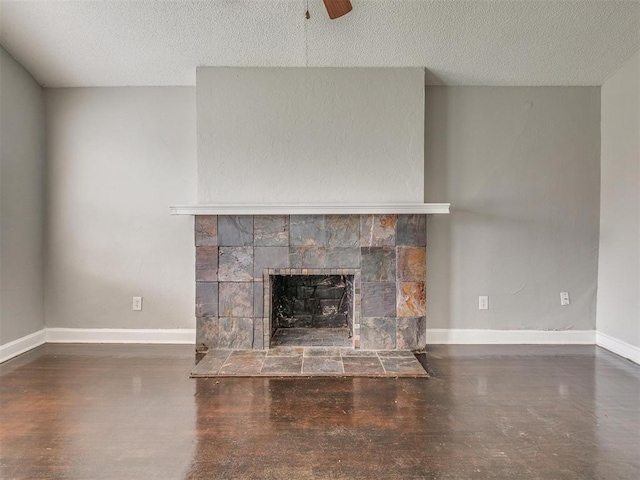 1817 NW 32nd St, Oklahoma City, OK 73118 - unfurnished living room with a textured ceiling, ceiling fan, a tile fireplace, and baseboards