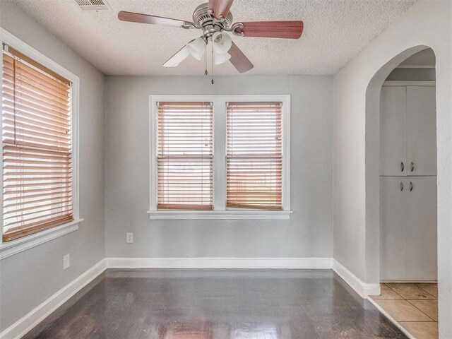 1817 NW 32nd St, Oklahoma City, OK 73118 - unfurnished room featuring a ceiling fan, arched walkways, a textured ceiling, and baseboards