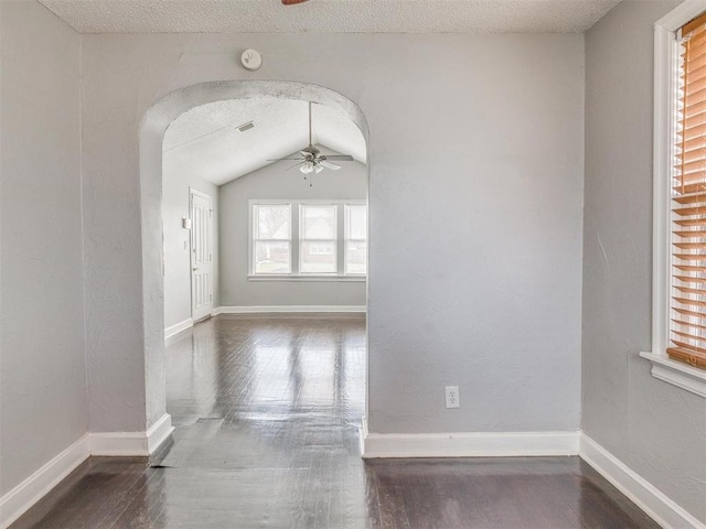 1817 NW 32nd St, Oklahoma City, OK 73118 - unfurnished room featuring a ceiling fan, arched walkways, baseboards, and wood finished floors