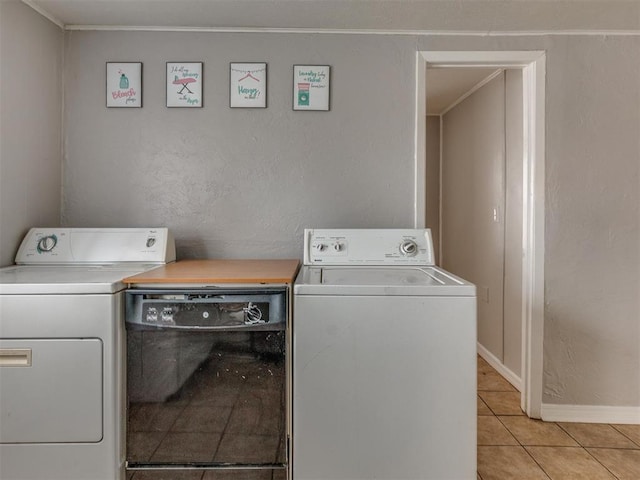 1817 NW 32nd St, Oklahoma City, OK 73118 - clothes washing area with light tile patterned floors, laundry area, ornamental molding, and washer and clothes dryer