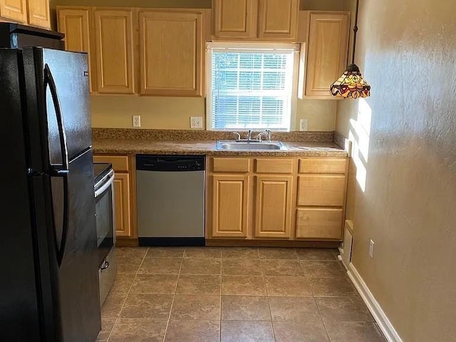 1817 NW 32nd St, Oklahoma City, OK 73118 - kitchen featuring light tile patterned floors, electric range oven, freestanding refrigerator, a sink, and dishwasher