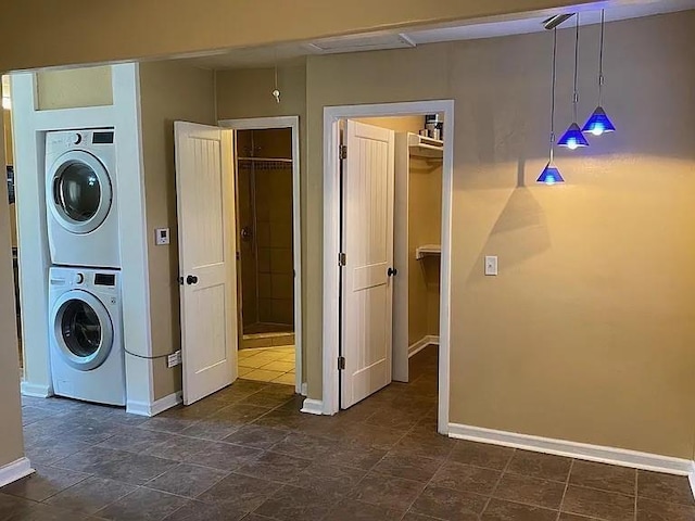 1817 NW 32nd St, Oklahoma City, OK 73118 - washroom featuring stacked washer / dryer, laundry area, and baseboards