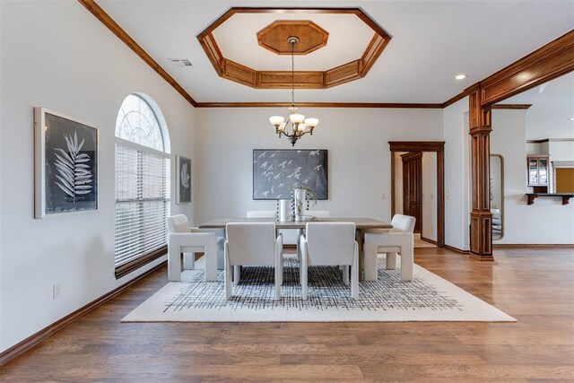 16513 Fenwick Blvd, Edmond, OK 73012 - dining area featuring a chandelier, crown molding, a raised ceiling, wood finished floors, and baseboards