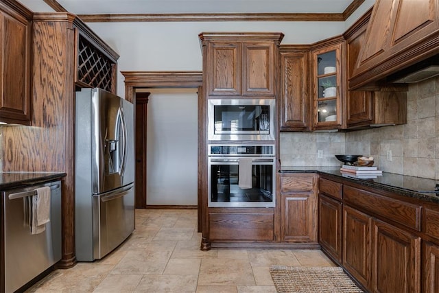 16513 Fenwick Blvd, Edmond, OK 73012 - kitchen with stainless steel appliances, tasteful backsplash, dark stone counters, ornamental molding, and glass insert cabinets