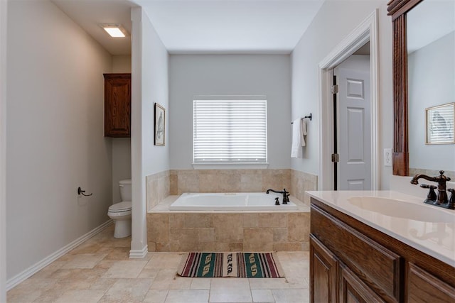 16513 Fenwick Blvd, Edmond, OK 73012 - bathroom with a garden tub, toilet, vanity, and baseboards
