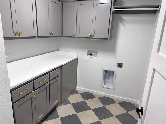 laundry room with cabinet space, baseboards, dark floors, hookup for a washing machine, and hookup for an electric dryer