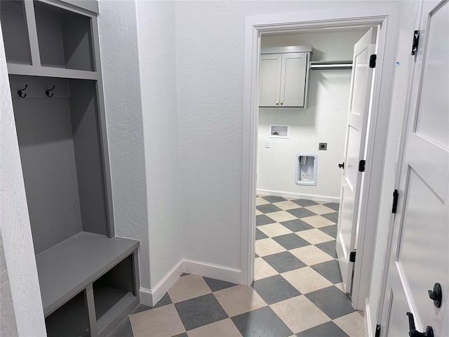 mudroom featuring baseboards and light floors