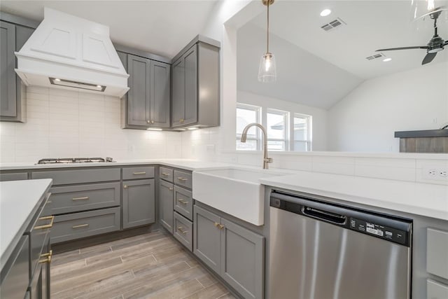 kitchen featuring custom exhaust hood, gray cabinets, and dishwasher