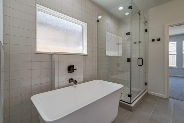 full bathroom with a shower stall, a freestanding tub, recessed lighting, and tile patterned floors