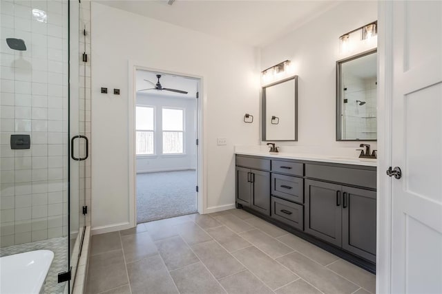 bathroom with a sink, a shower stall, and a ceiling fan