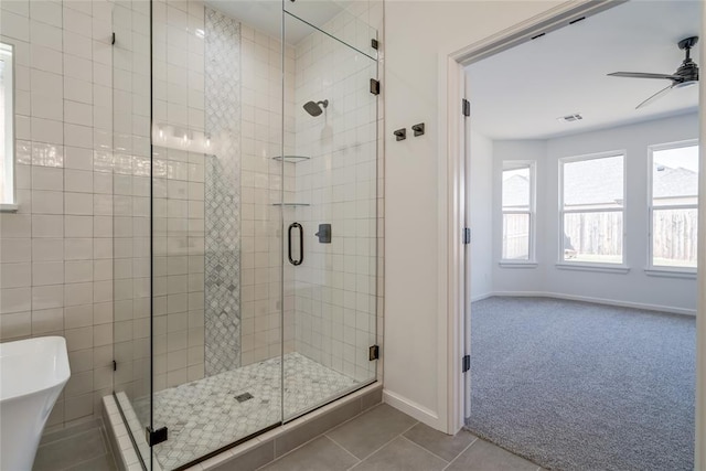 full bathroom with baseboards, tile patterned flooring, a shower stall, visible vents, and ceiling fan