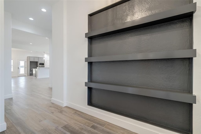 interior details with baseboards, recessed lighting, and wood finished floors