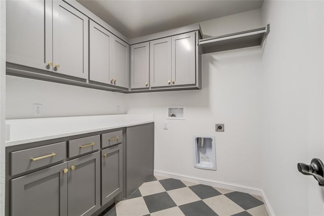 laundry area with baseboards, hookup for an electric dryer, cabinet space, tile patterned floors, and hookup for a washing machine