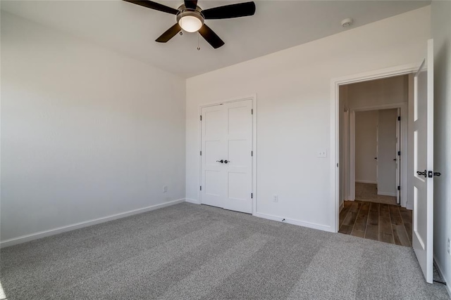 unfurnished bedroom featuring baseboards, ceiling fan, and carpet