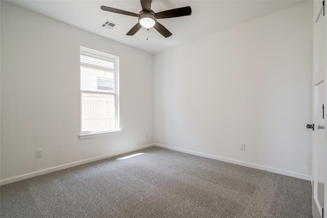carpeted spare room with ceiling fan, baseboards, and visible vents