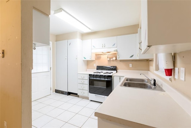 kitchen featuring under cabinet range hood, white range with gas stovetop, a sink, white cabinetry, and light countertops