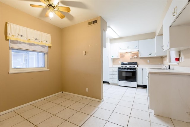 kitchen featuring light tile patterned flooring, white range oven, visible vents, white cabinets, and light countertops