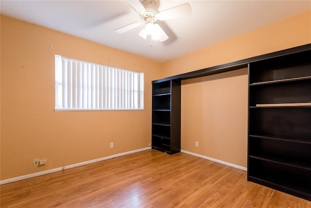 unfurnished bedroom featuring light wood-type flooring, ceiling fan, and baseboards