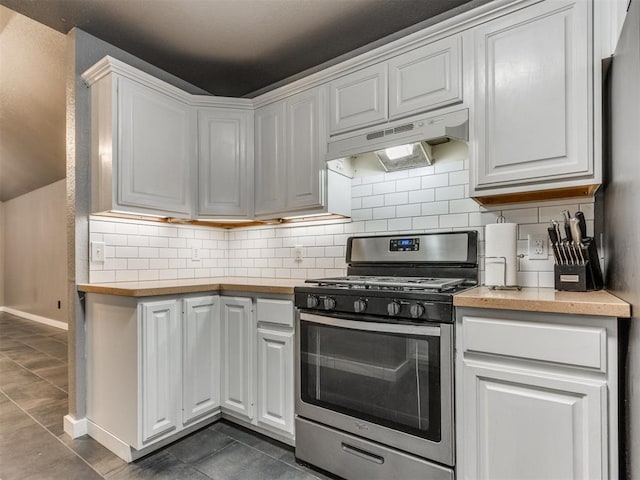 kitchen with light countertops, decorative backsplash, white cabinets, stainless steel range with gas stovetop, and under cabinet range hood